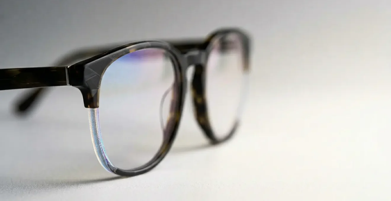 Close-up view of modern eyeglass lenses showing anti-reflective coating technology with clean optical clarity