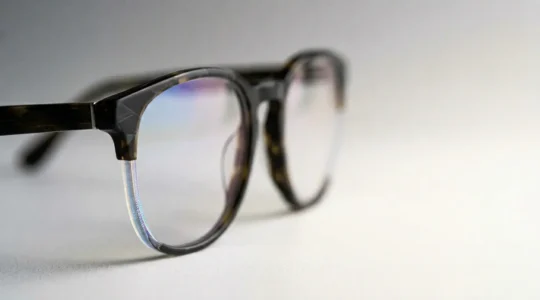 Close-up view of modern eyeglass lenses showing anti-reflective coating technology with clean optical clarity