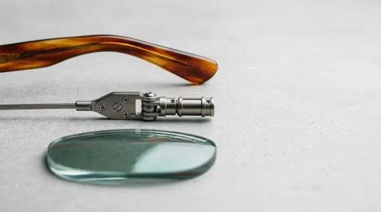 A detailed close-up view of premium eyewear components showcasing the intersection of designer craftsmanship and optical technology