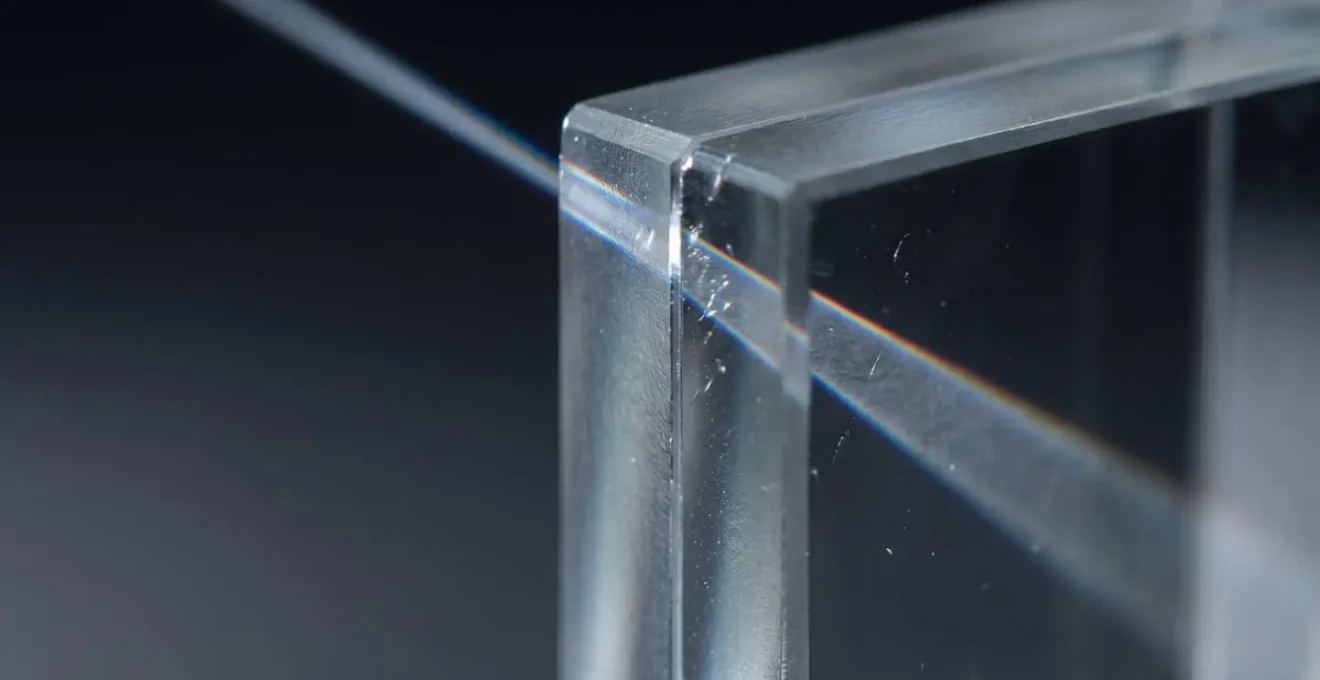 Macro photography revealing optical quality differences through light dispersion patterns in various lens materials
