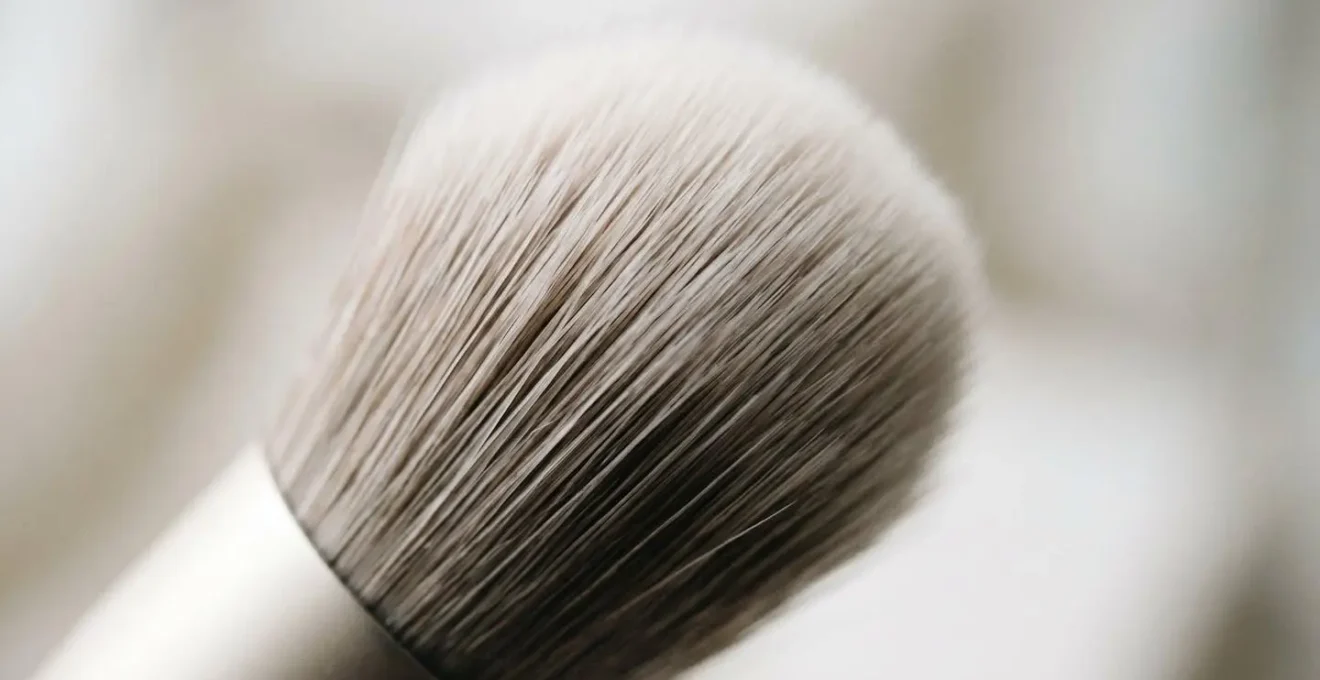Macro photograph of makeup brush bristles showing intricate fiber texture and structure, emphasizing hygiene and bacterial accumulation risk